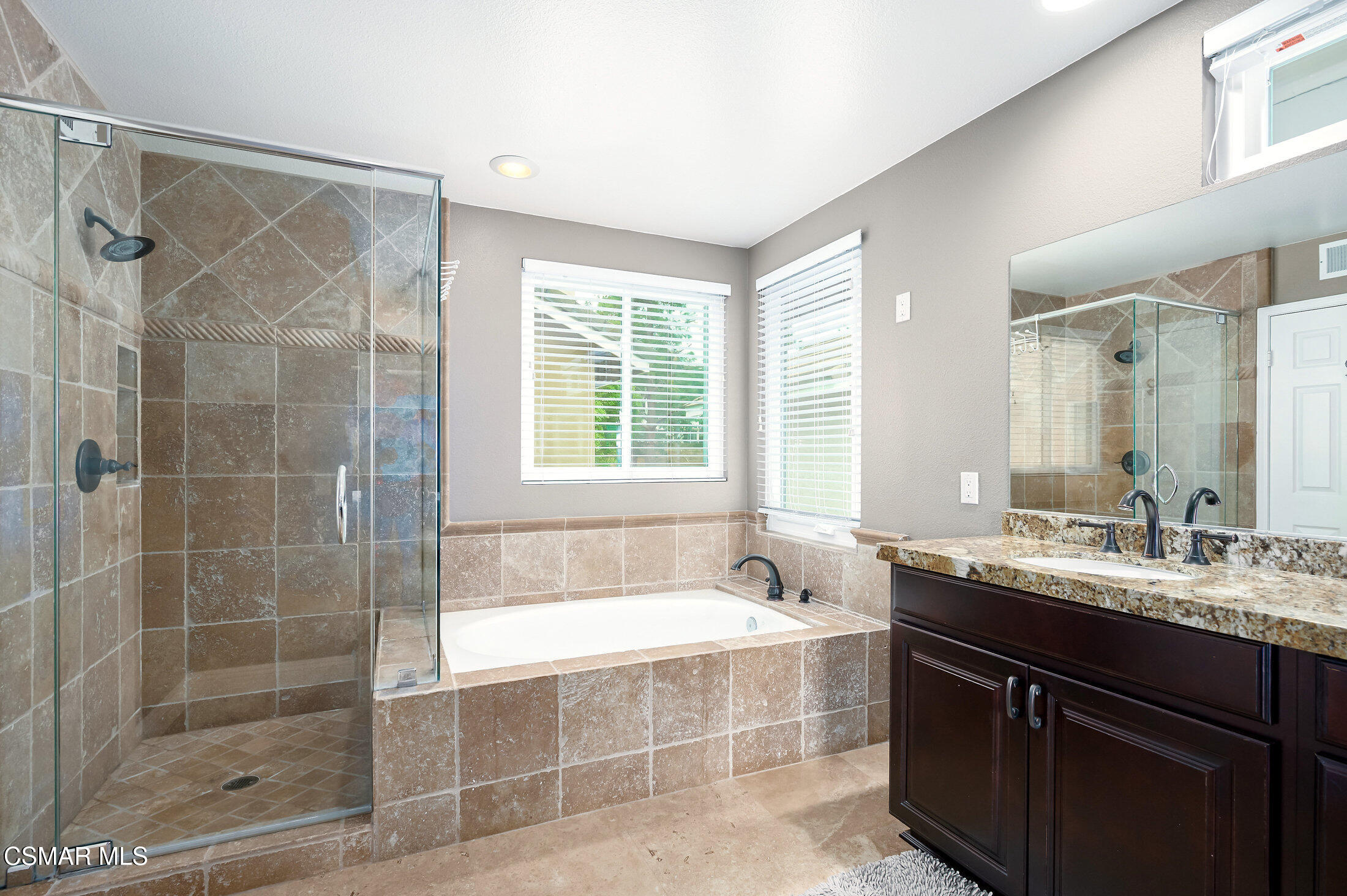 12142 Cherry Grove Street Moorpark, CA 93021 - Photo 21 of 36 a bathroom with a tub sink shower and a mirror