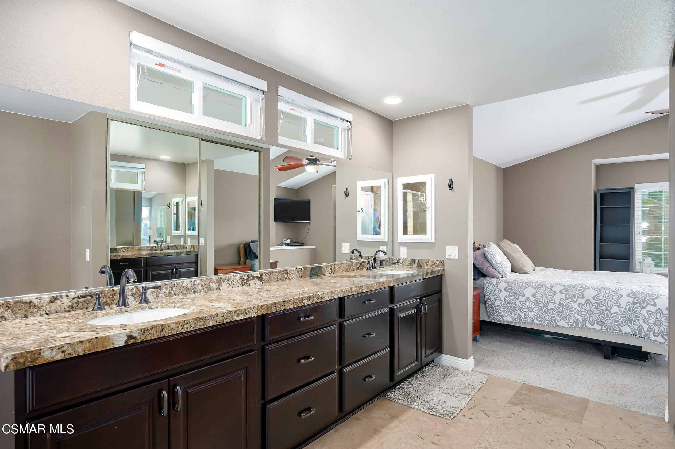12142 Cherry Grove Street Moorpark, CA 93021 - Photo 22 of 36 a en suite bathroom with a granite countertop double vanity sink and a mirror
