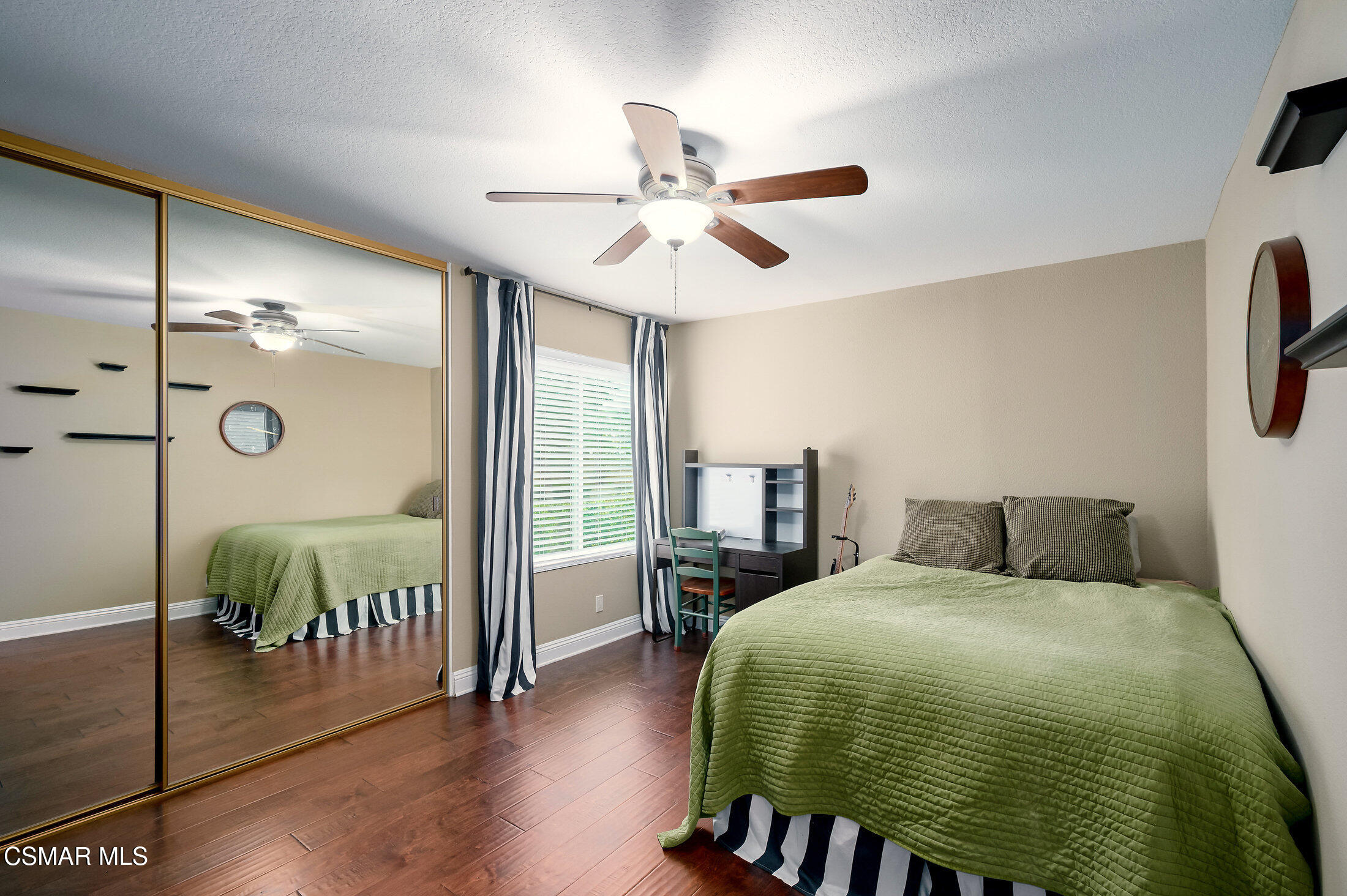 12142 Cherry Grove Street Moorpark, CA 93021 - Photo 23 of 36 a bedroom with a bed and wooden floor