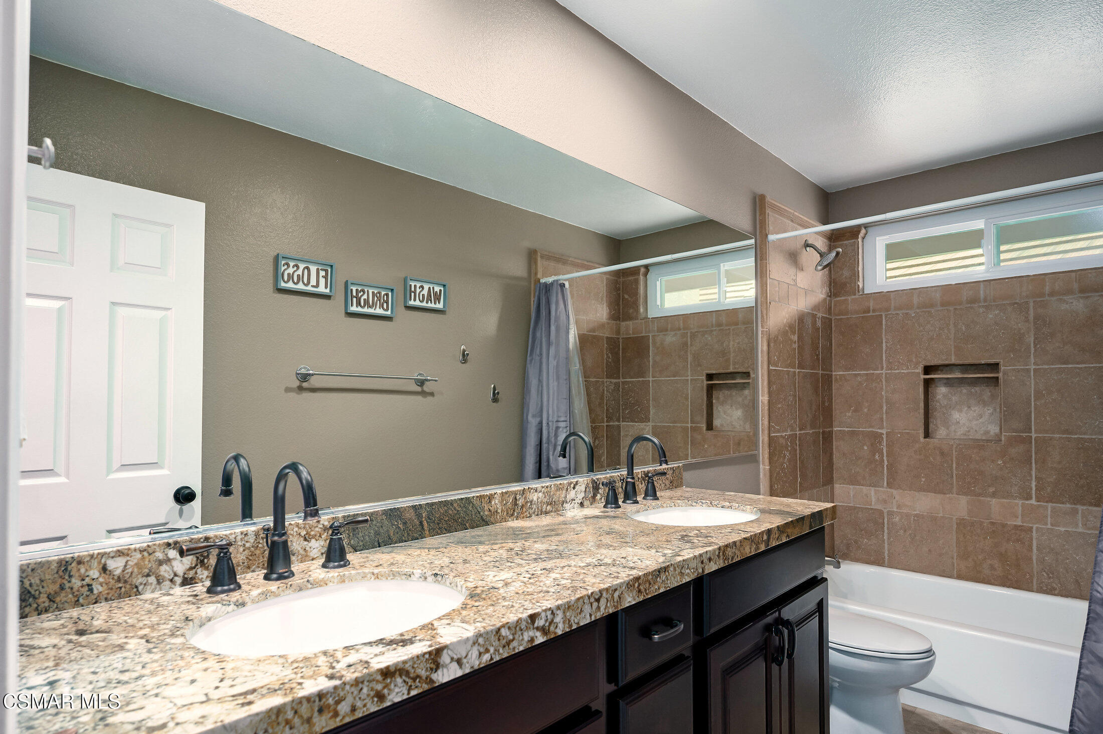 12142 Cherry Grove Street Moorpark, CA 93021 - Photo 25 of 36 a bathroom with a granite countertop sink a toilet and shower