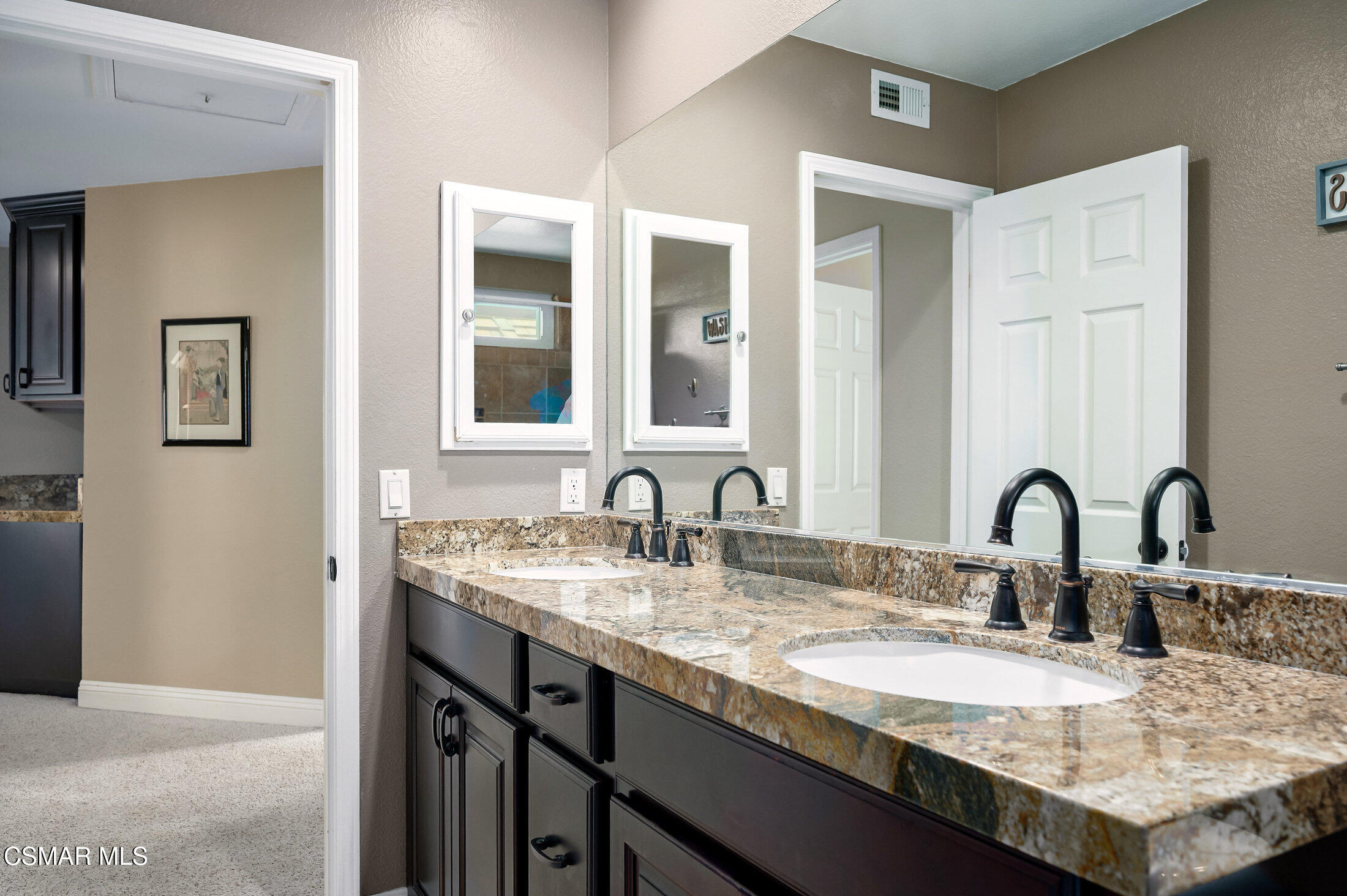 12142 Cherry Grove Street Moorpark, CA 93021 - Photo 26 of 36 a bathroom with a granite countertop sink a large mirror and vanity