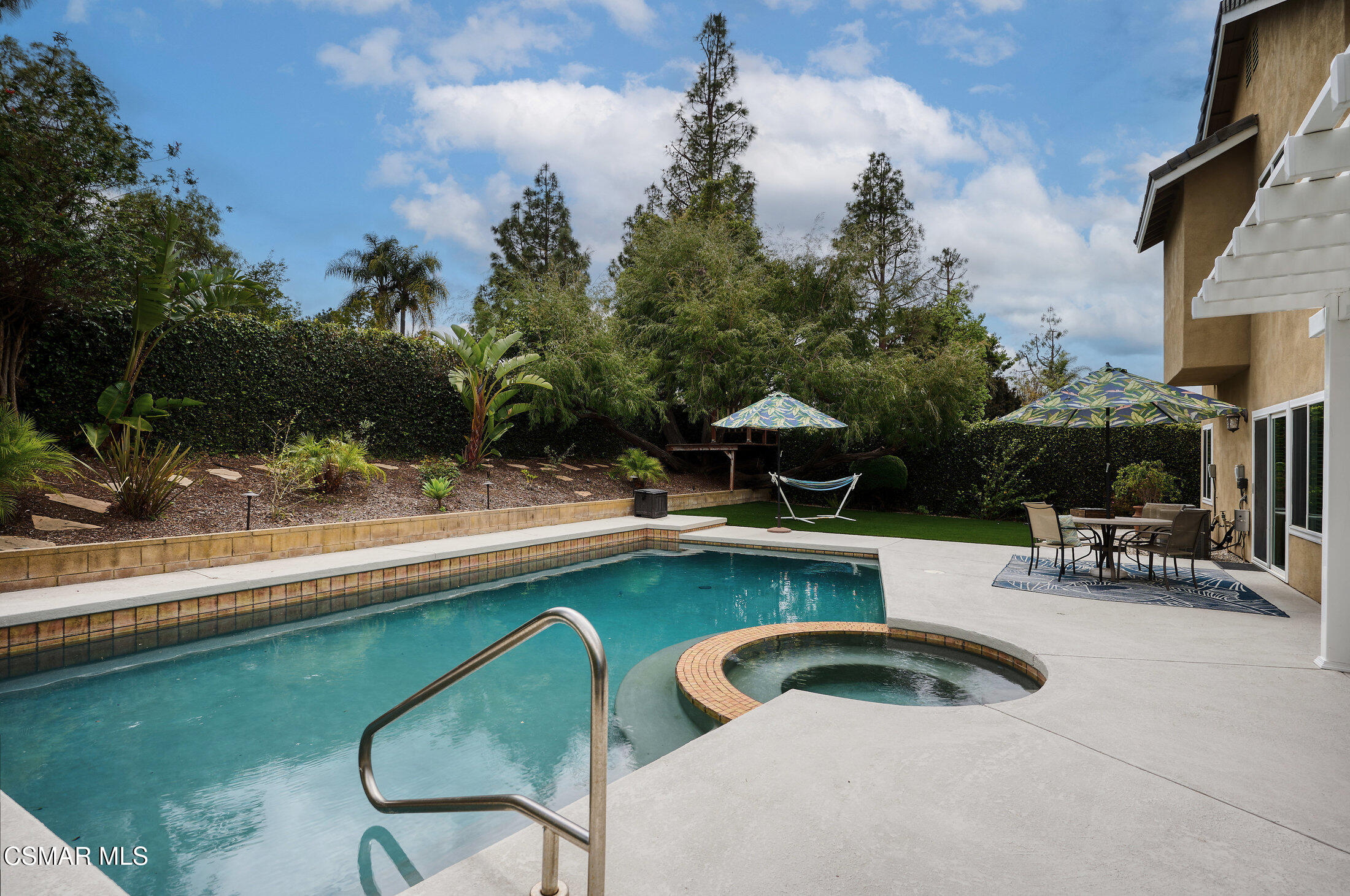 12142 Cherry Grove Street Moorpark, CA 93021 - Photo 32 of 36 a view of swimming pool with outdoor seating and trees in the background