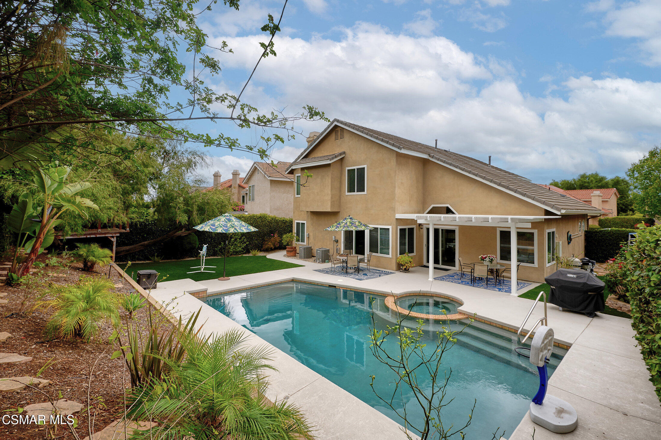12142 Cherry Grove Street Moorpark, CA 93021 - Photo 33 of 36 a view of a house with pool and chairs