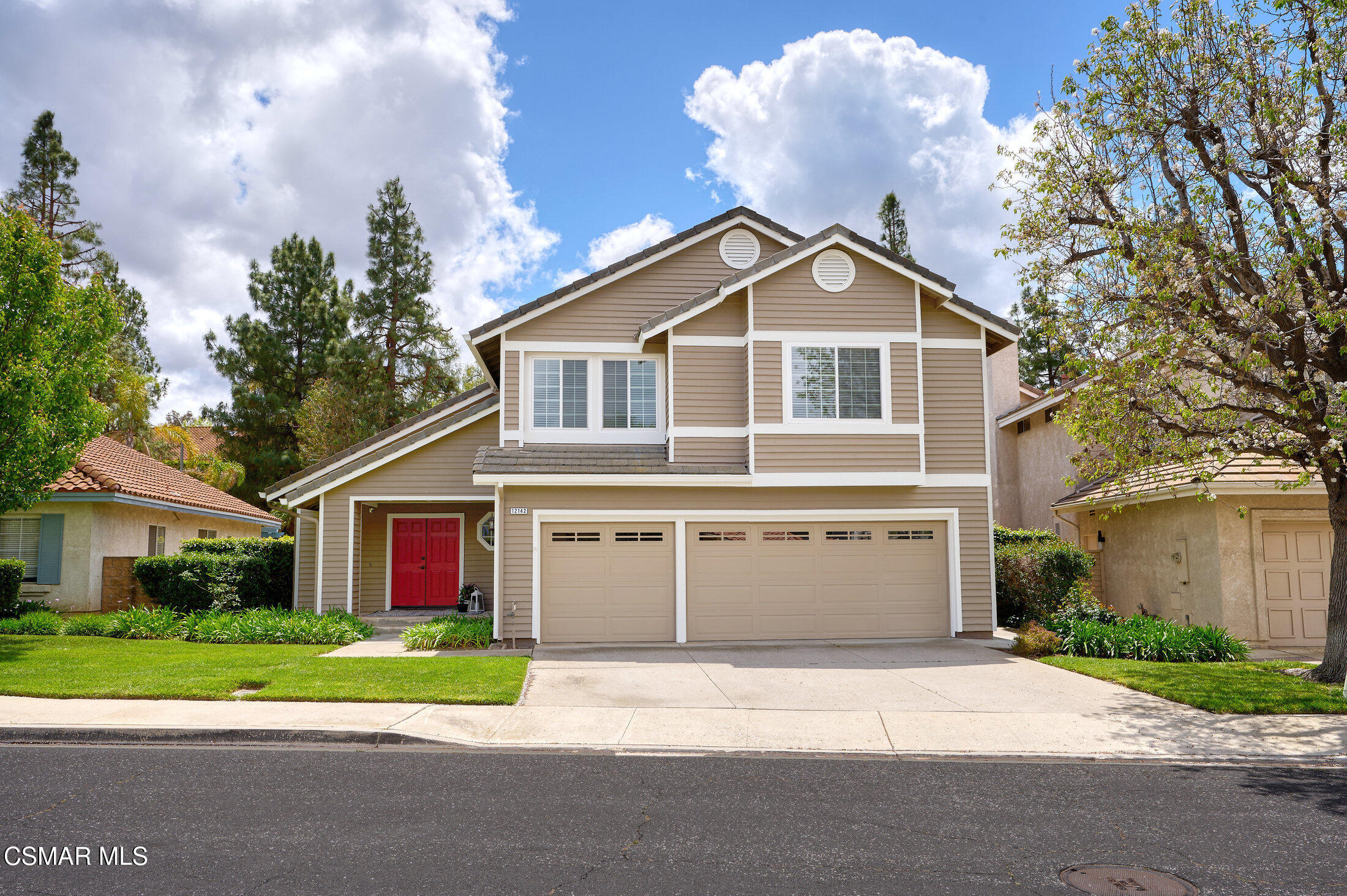 12142 Cherry Grove Street Moorpark, CA 93021 - Photo 36 of 36 a front view of a house with a yard and garage