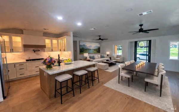 a kitchen with lots of counter top space and dining table