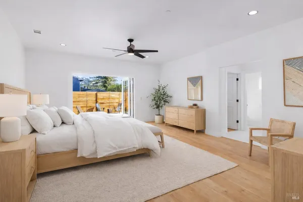 a bedroom with bed and ceiling fan