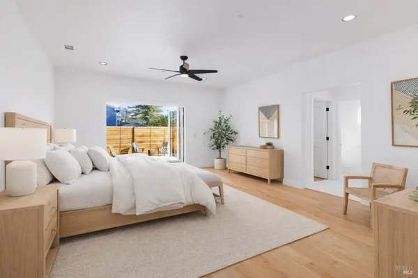 a spacious bedroom with a bed and window