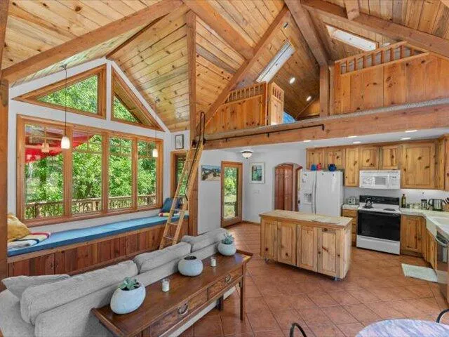 a living room with fireplace furniture and a floor to ceiling window