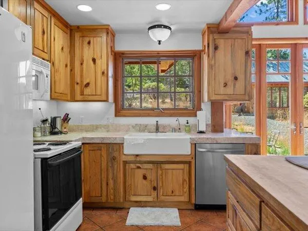 a view of an empty room with wooden floor and closet