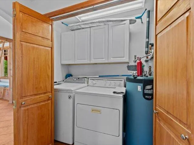 a view of a patio with a table and chairs under an umbrella with a large tree