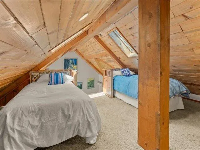 a view of a patio with table and chairs with wooden floor and fence