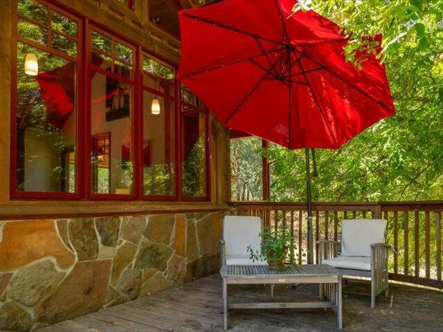 a view of a lush green field with mountains in the background