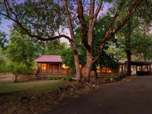 a kitchen that has a lot of white cabinets and stainless steel appliances