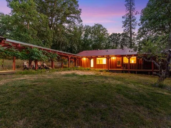 a kitchen with granite countertop a sink stove and cabinets