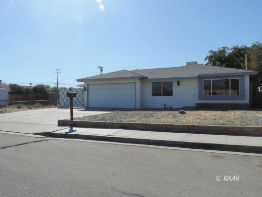 709 West Alene Avenue Ridgecrest, CA 93555 - Photo 2 of 20 a front view of a house with a garden