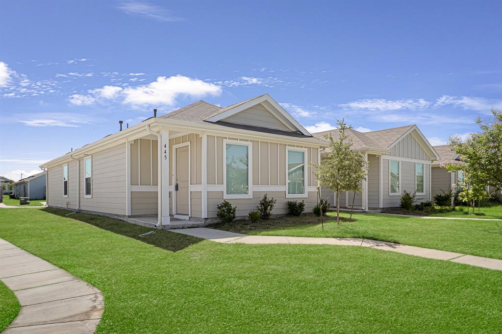 445 Reverie Way Ferris, TX 75125 - Photo 1 of 1 View of front of property with a front yard, board and batten siding, and a shingled roof