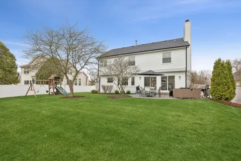 a view of a house with a backyard