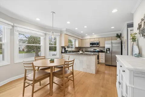 a kitchen with stainless steel appliances granite countertop counter space a sink and a refrigerator