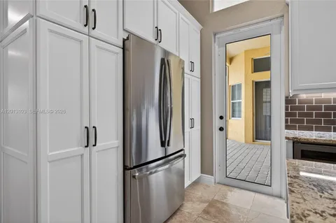 a view of a hallway with wooden floor and closet
