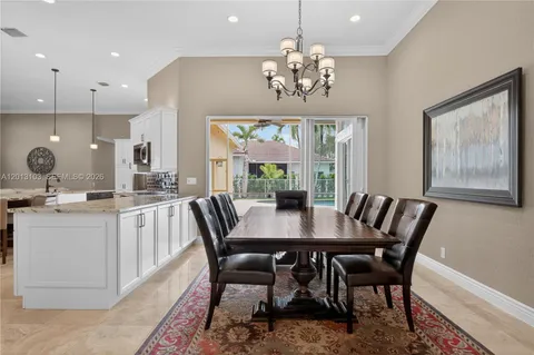 a living room with furniture kitchen view and a chandelier
