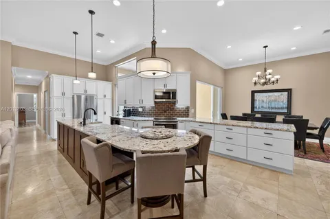 a view of a dining room with furniture a chandelier and wooden floor