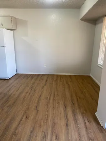 a view of an empty room and wooden floor