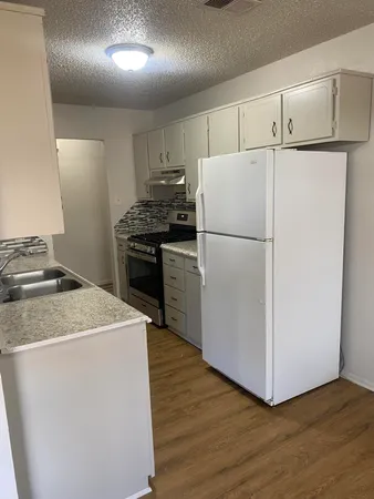 a white refrigerator freezer sitting in a kitchen