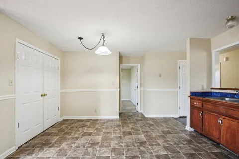 a view of a room with a sink and cabinets