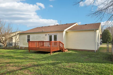 a backyard of a house with barbeque oven and outdoor seating