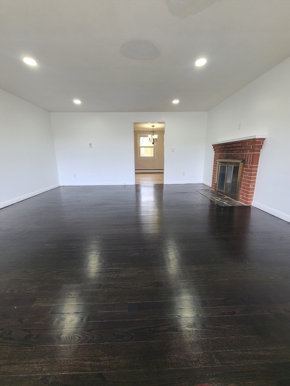 1669 Main Street, Unit A Leicester, MA 01524 - Photo 1 of 7 an empty room with wooden floor and windows
