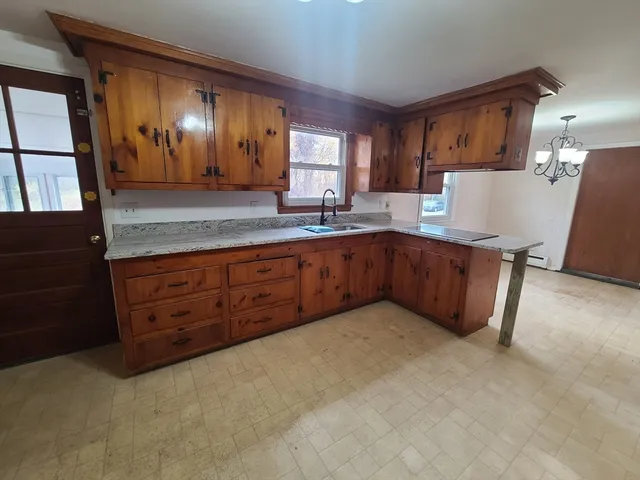 a view of a kitchen with a sink cabinets and a window