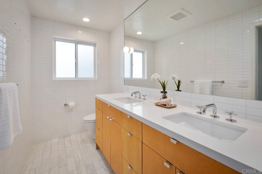 405 9th Street Del Mar, CA 92014 - Photo 14 of 25 a bathroom with a sink and a mirror