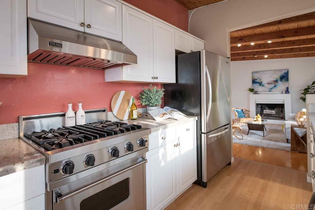 405 9th Street Del Mar, CA 92014 - Photo 7 of 25 a kitchen with stainless steel appliances granite countertop a stove and a refrigerator