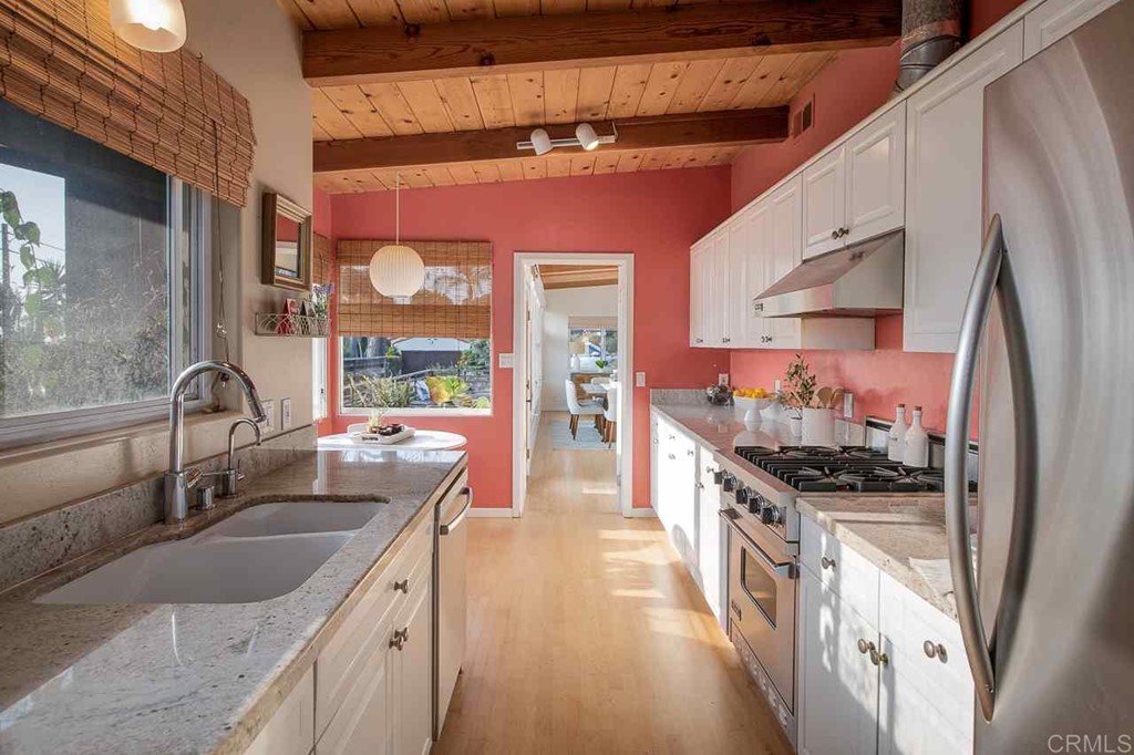405 9th Street Del Mar, CA 92014 - Photo 8 of 25 a kitchen with stainless steel appliances granite countertop a sink and a stove