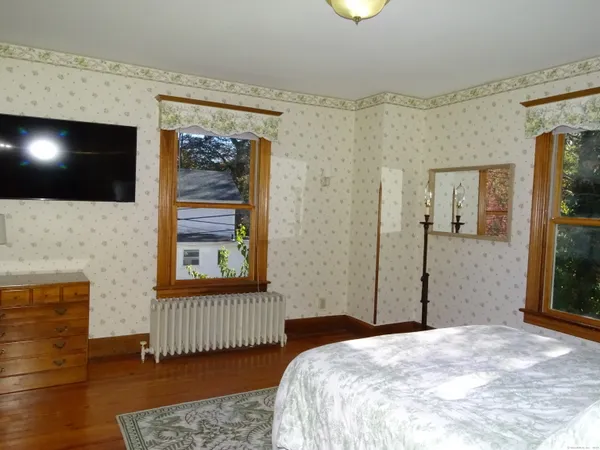 a bed sitting in a bedroom next to a window