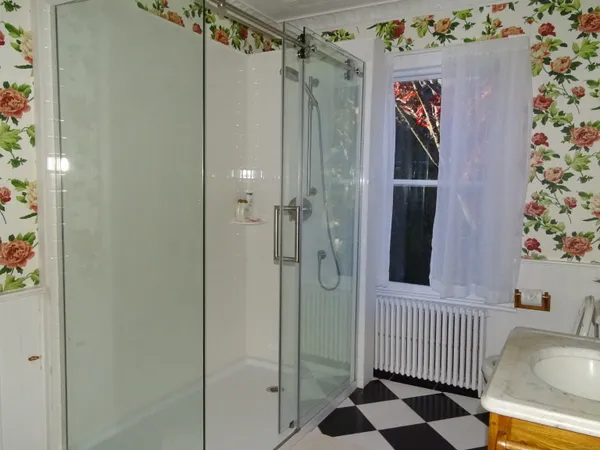 a bed sitting in a bedroom next to a small window