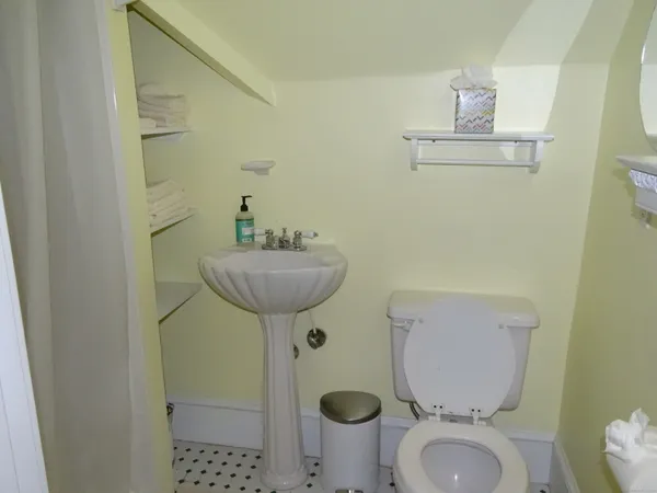 a bedroom with a bed and a flat tv screen next to a window