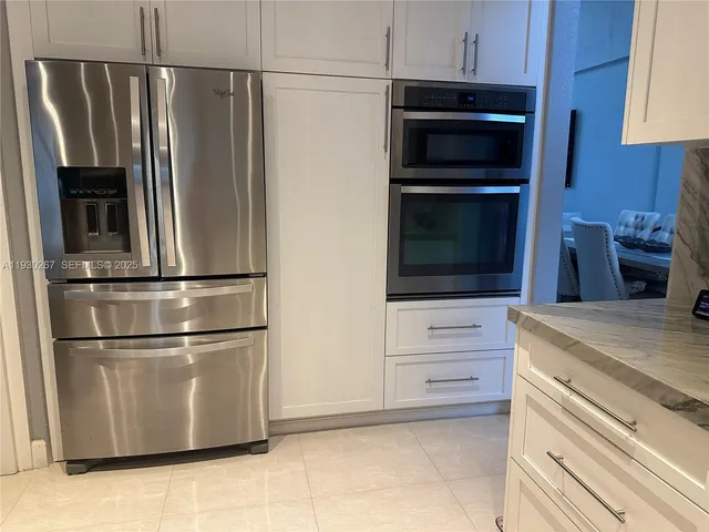 a kitchen with stainless steel appliances a sink a stove and a refrigerator