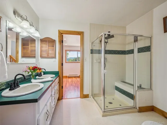 a bathroom with a sink double vanity and a shower