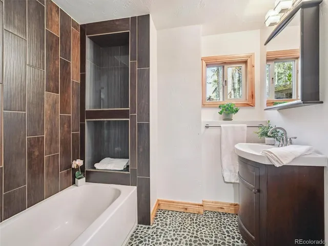 a bathroom with a sink a mirror and a bathtub