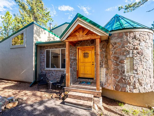 a backyard of a house with barbeque oven table and chairs