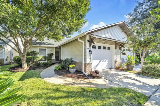 a view of a house with backyard and a tree