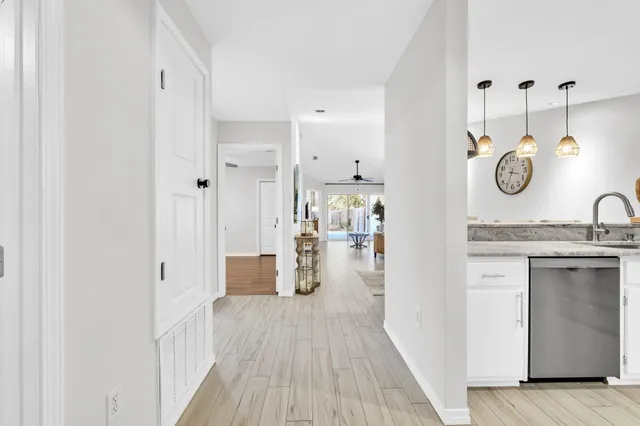 a kitchen with a sink and wooden floor