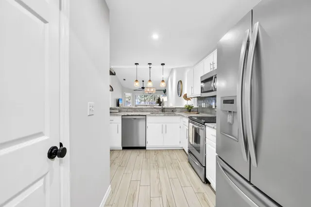 a bathroom with a double vanity sink mirror and toilet
