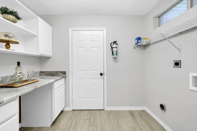 a view of a livingroom with furniture and a potted plant