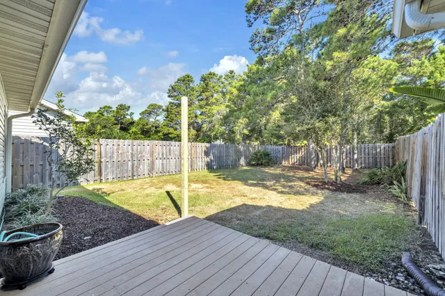 a view of a backyard with wooden fence