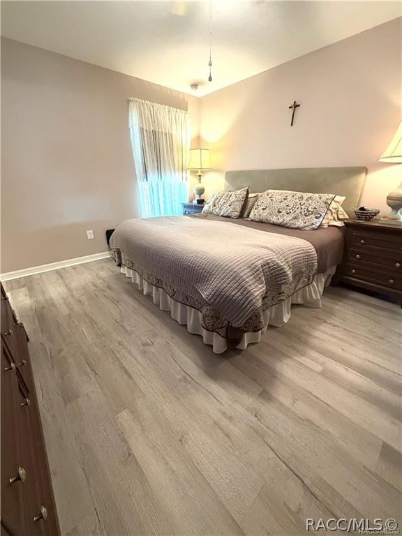 13591 Southwest 112th Street Dunnellon, FL 34432 - Photo 16 of 24 a spacious bedroom with a bed and a window
