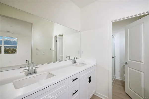 a bathroom with a sink vanity granite and a mirror