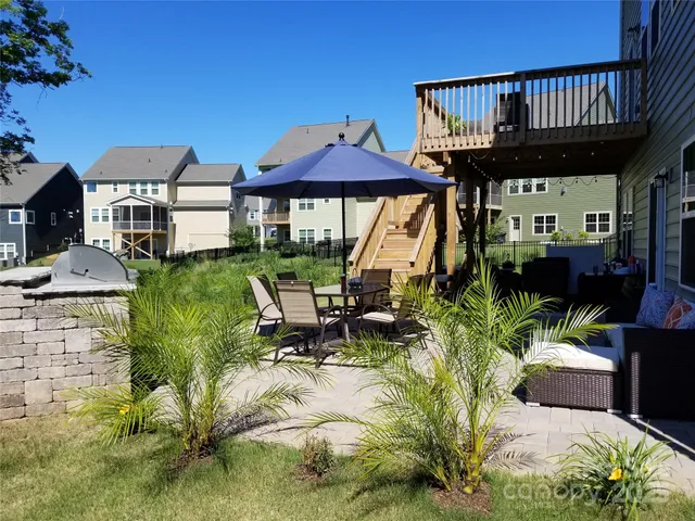 a view of a house with backyard sitting area and garden