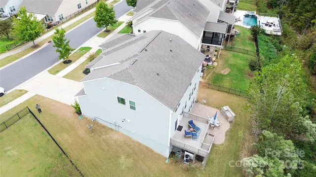 an aerial view of residential house with outdoor space and parking